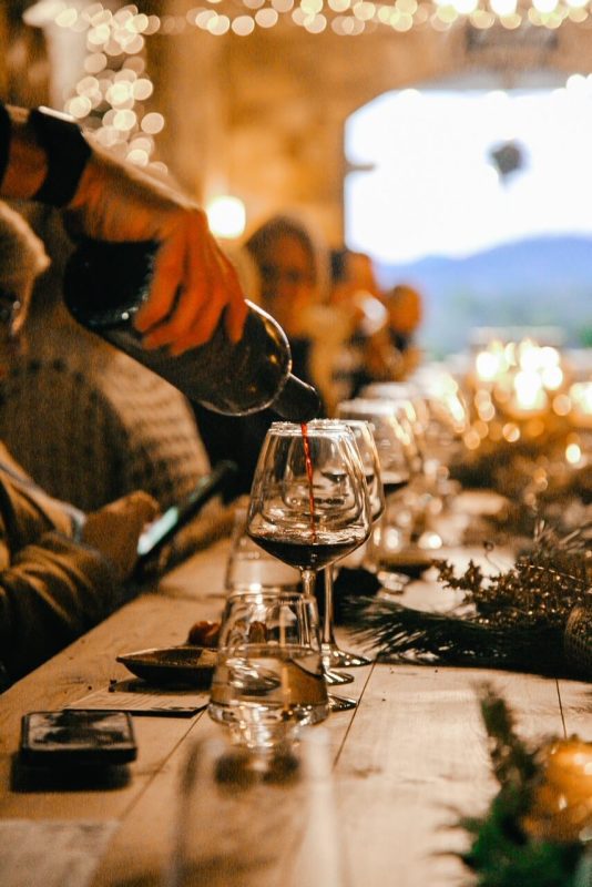 a group drinking wine in the barrell room