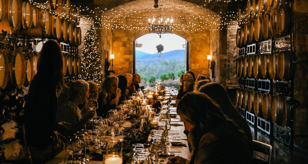 a large gathering in the barrel room