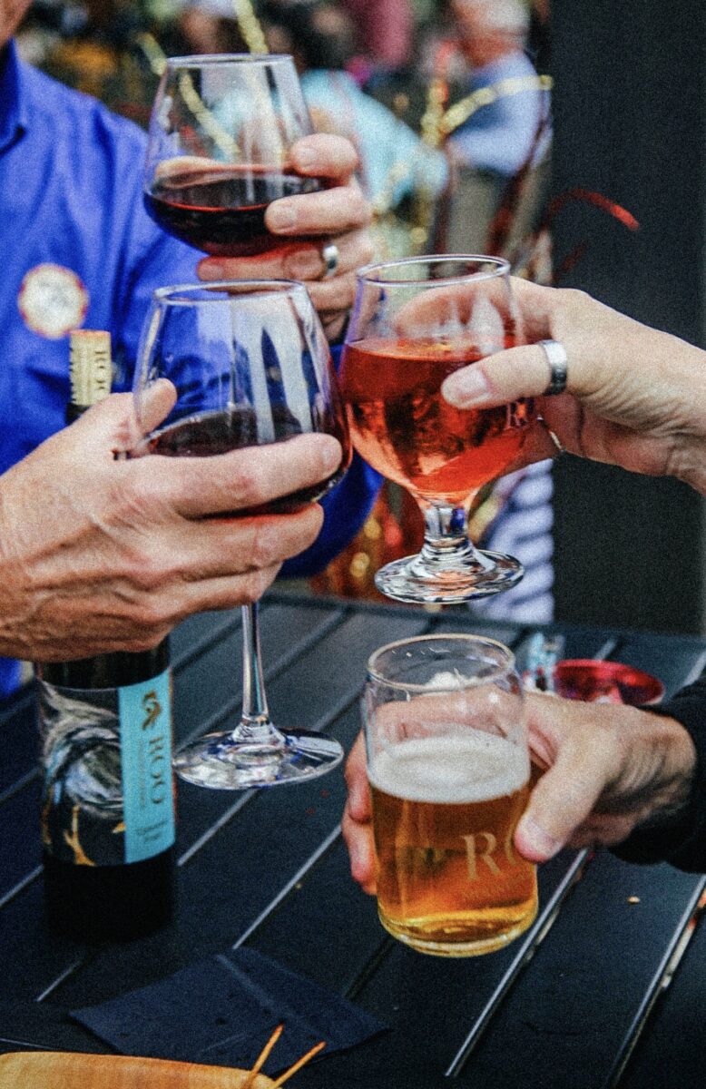 a group cheers with wine glasses